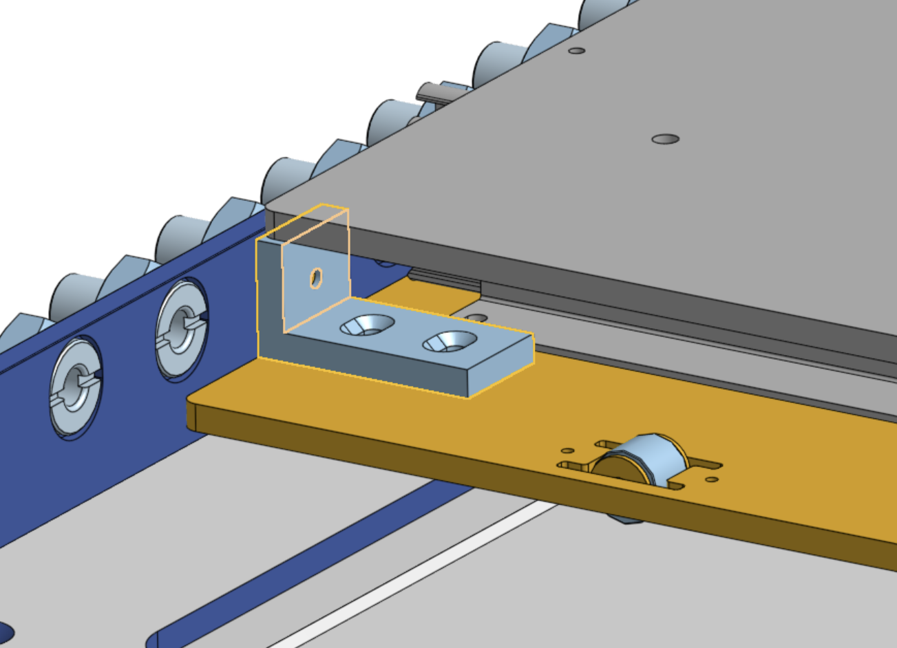 Close-up of a highlighted aluminum angle block screwed to the yellow slide plate, butting against the edge of the gray instrument plate, with a roller set into the slide plate